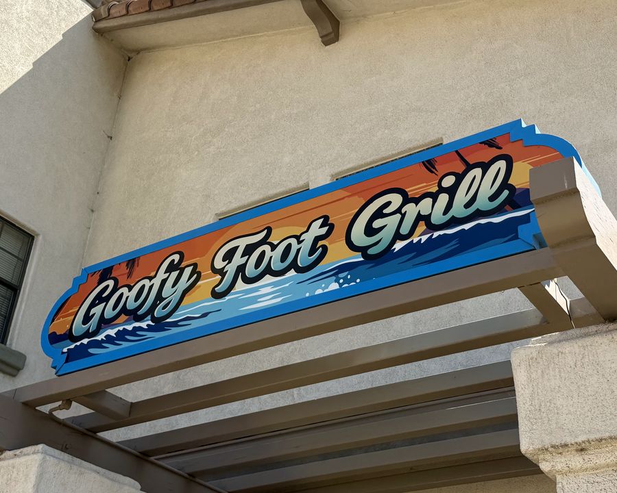 The painted Goofy Foot Grill sign above the entrance on West Grand Avenue.